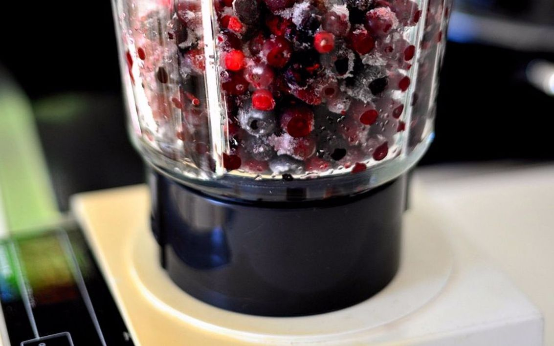 A green vitality smoothie topped with coconut flakes